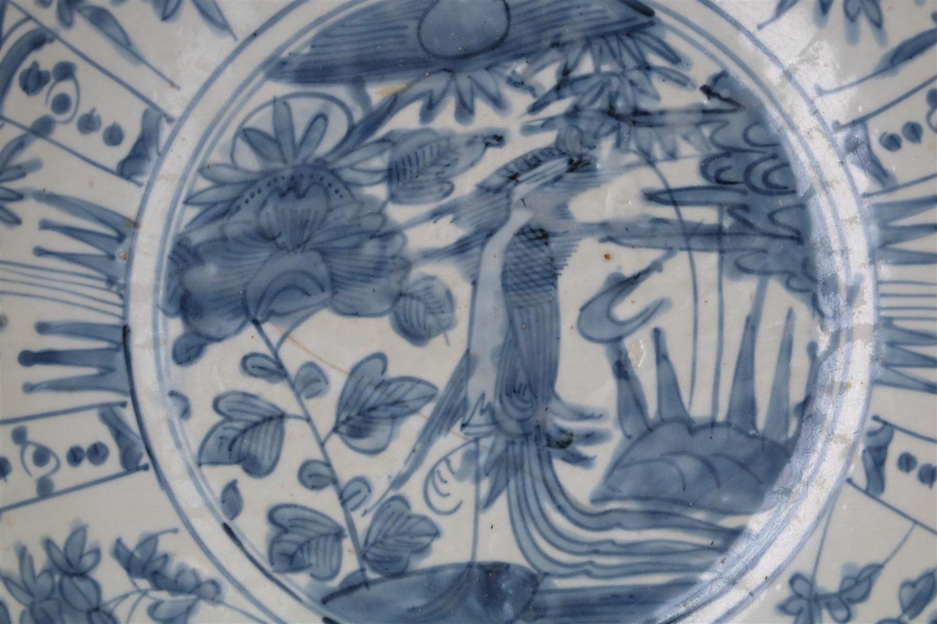 A blue and white porcelain deep charger, decorated with flowers and a water bird. Unmarked. China, - Image 4 of 4