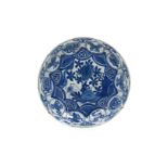 A blue and white 'kraak' porcelain dish with a scalloped rim, decorated with a cricket on a rock and