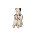 A sculpture of Cizhou ware depicting a sitting boy. China, 20th century.Provenance: bought in Hong