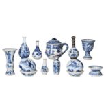 Lot of diverse blue and white porcelain objects, including lidded boxes, salt cellar, miniature