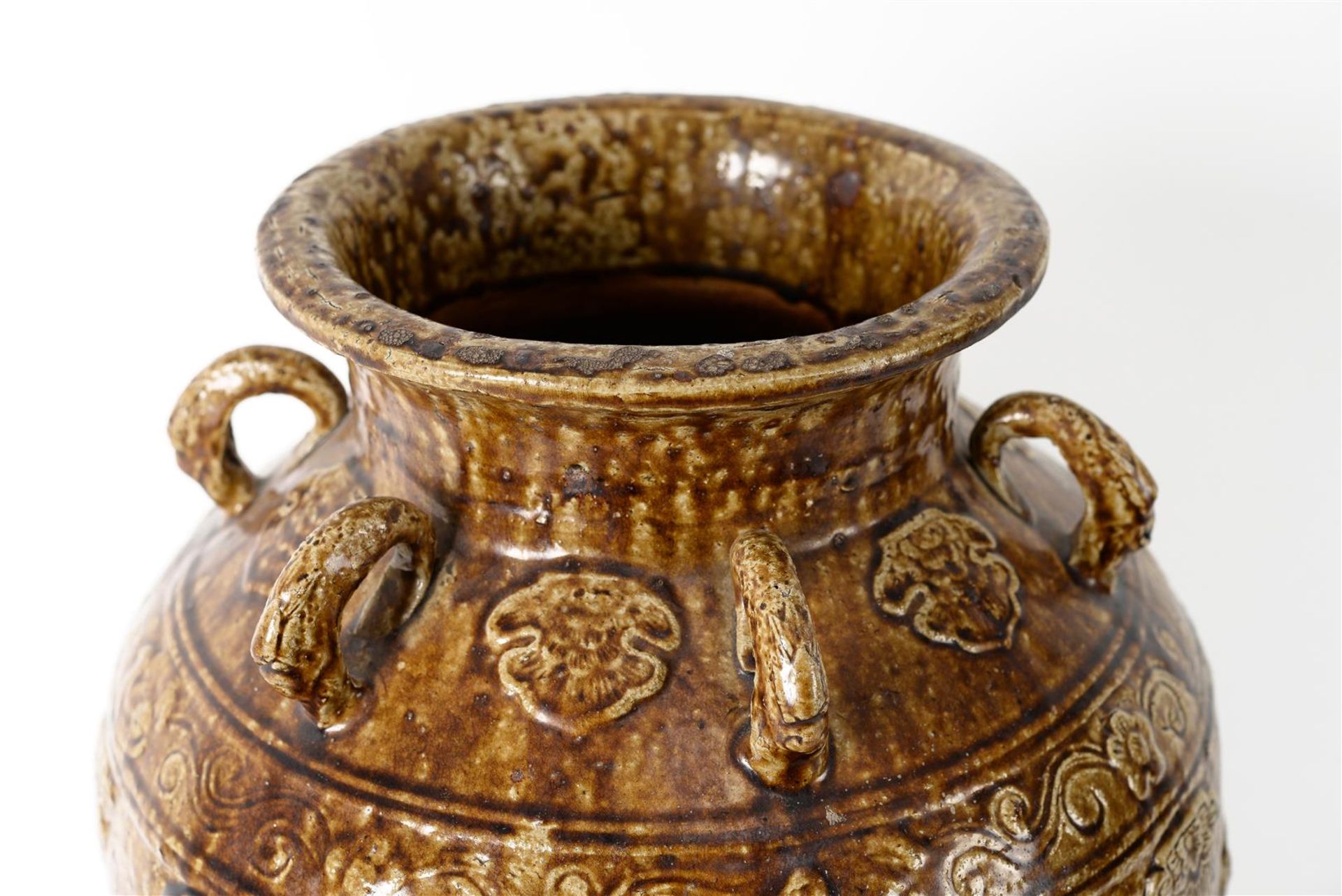 A glazed pottery martaban jar with six rings, decorated in relief with dragons and flowers. - Image 4 of 6