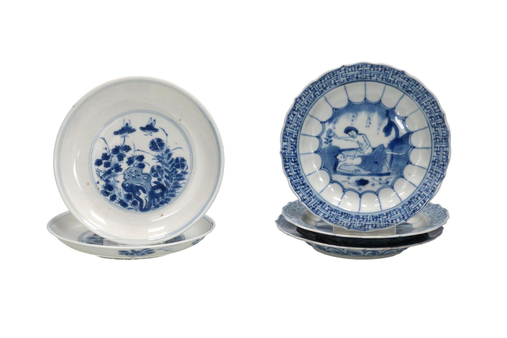 Lot of five blue and white porcelain saucers, two with a floral decoration and three with an