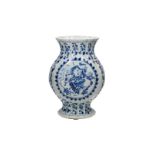 A blue and white ribbed porcelain vase, decorated with two medallions in which a boy with a frog and