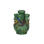 A green glazed tulip vase with five tubes, decorated with animals in relief. Marked with 6-character