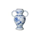 A blue and white porcelain vase with two handles in the shape of elephant trunks, decorated with
