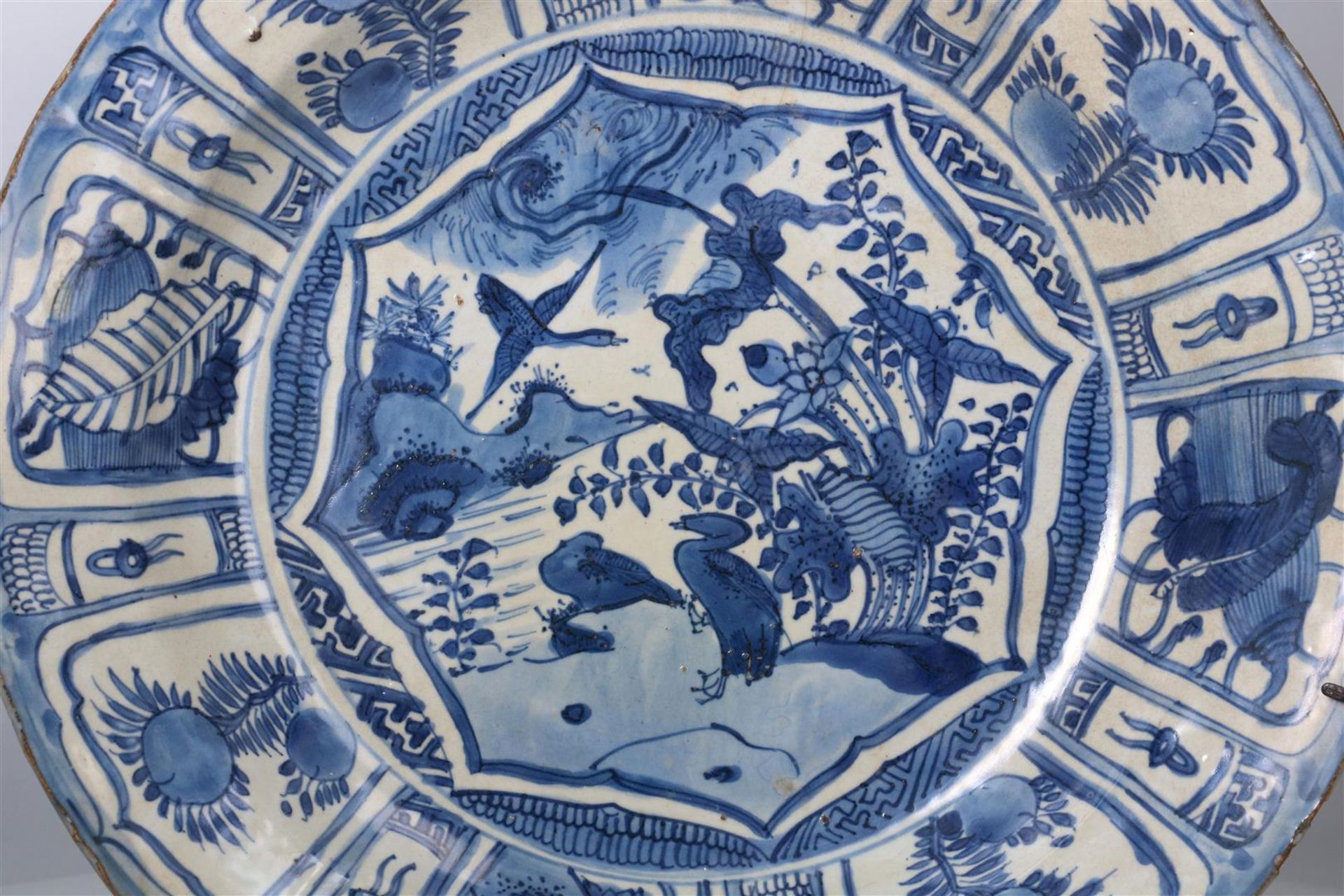 A blue and white porcelain deep charger, decorated with reserves depicting flowers, antiquities - Image 2 of 4
