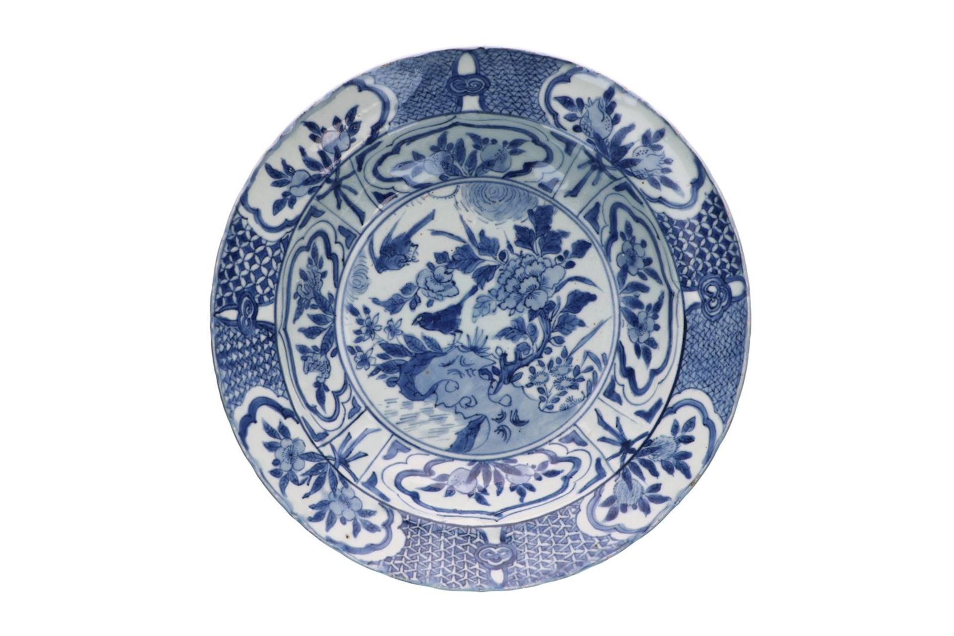 A blue and white 'kraak' porcelain deep dish, decorated with flowers, fruits and birds. Unmarked.