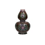 A polychrome double gourd porcelain vase with a famille rose decoration depicting lotus flowers,