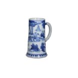 A blue and white porcelain beer mug decorated with an outdoor scene with seated figures. Unmarked.