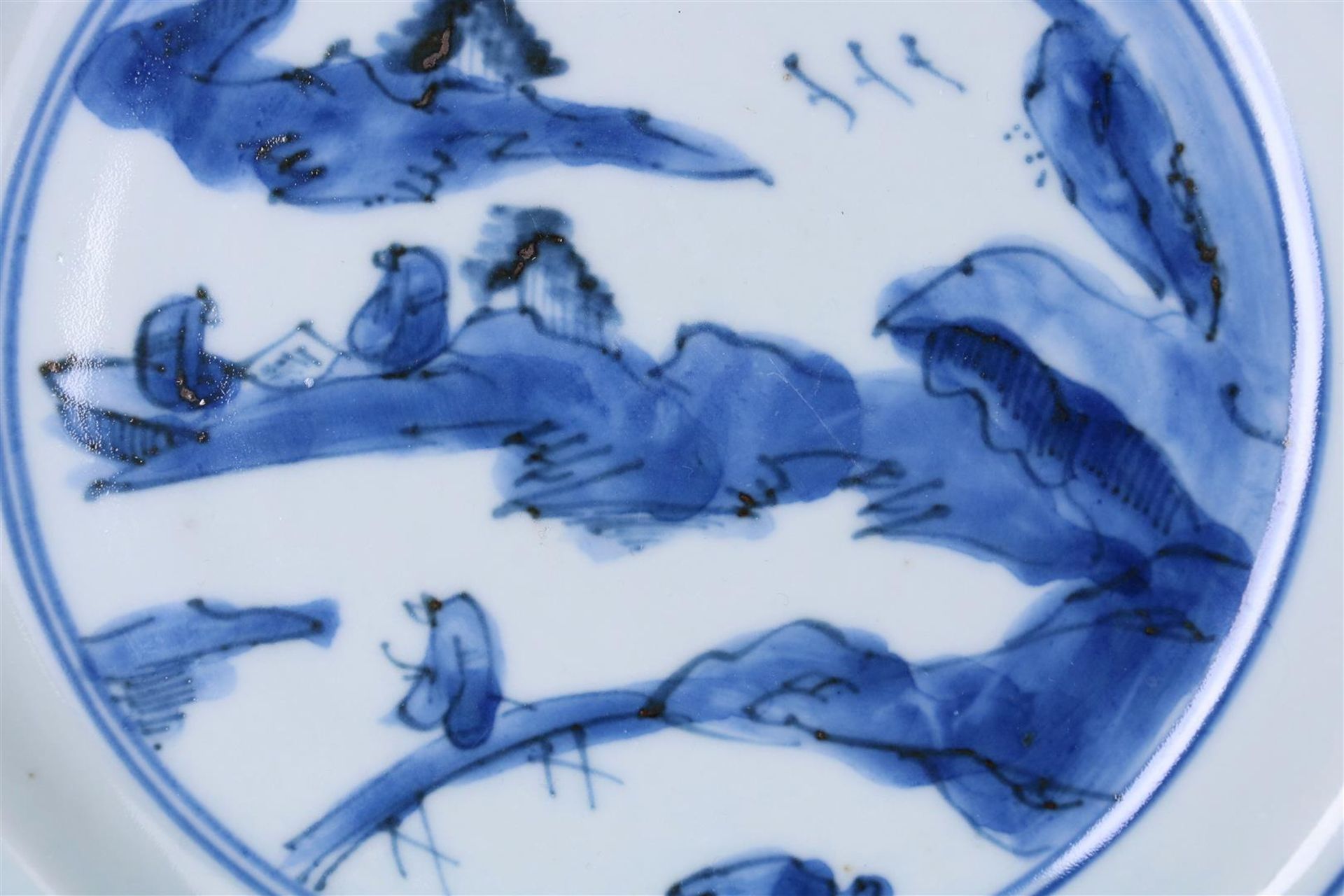 A blue and white porcelain dish, decorated with two reading monks in a mountainous landscape. - Image 2 of 4