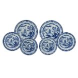 A set of six blue and white porcelain chargers, decorated with pagodas in a river landscape.