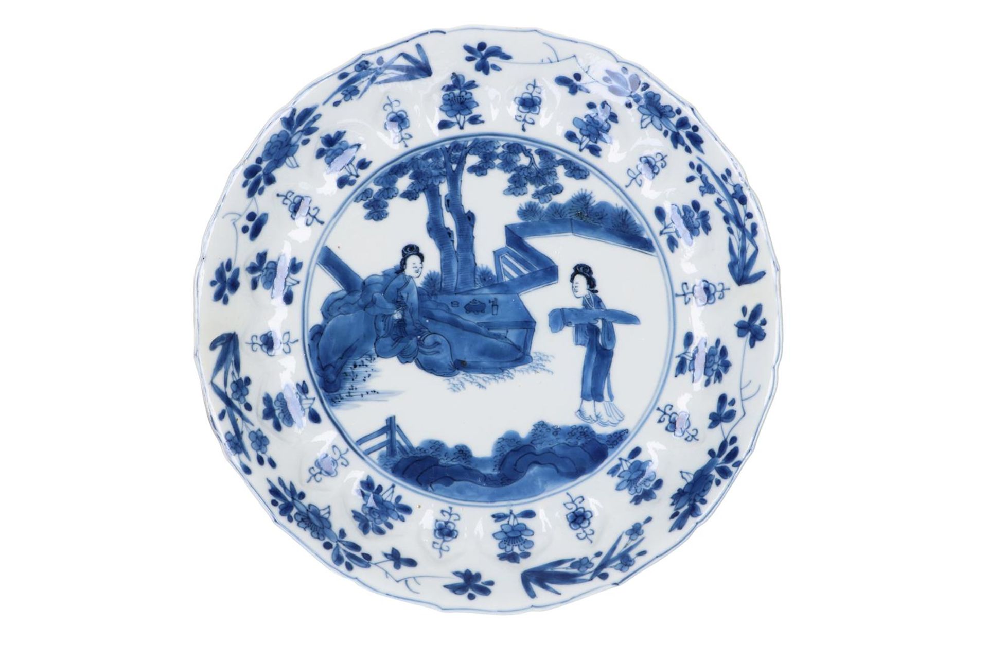 A blue and white porcelain dish with scalloped rim, decorated with ladies in a garden and flowers. - Image 3 of 5