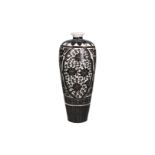 A black and white earthenware Meiping vase, after Song model, with a floral decor. China, 20th
