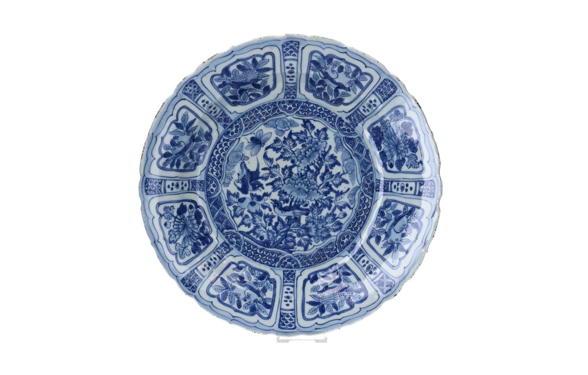A blue and white 'kraak' porcelain charger with scalloped rim, decorated with flowers, birds, a