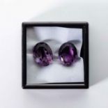 A PAIR OF UNMOUNTED OVAL MIXED-CUT AMETHYSTS