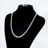 A DIAMOND NECKLACE AND MATCHING EARRINGS