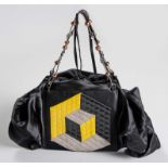 AN EMANUEL UNGARO SATIN AND LEATHER CLUTCH