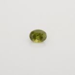 AN UNMOUNTED OVAL MIXED-CUT DEMANTOID GARNET