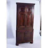 A GEORGE III MAHOGANY CORNER CUPBOARD