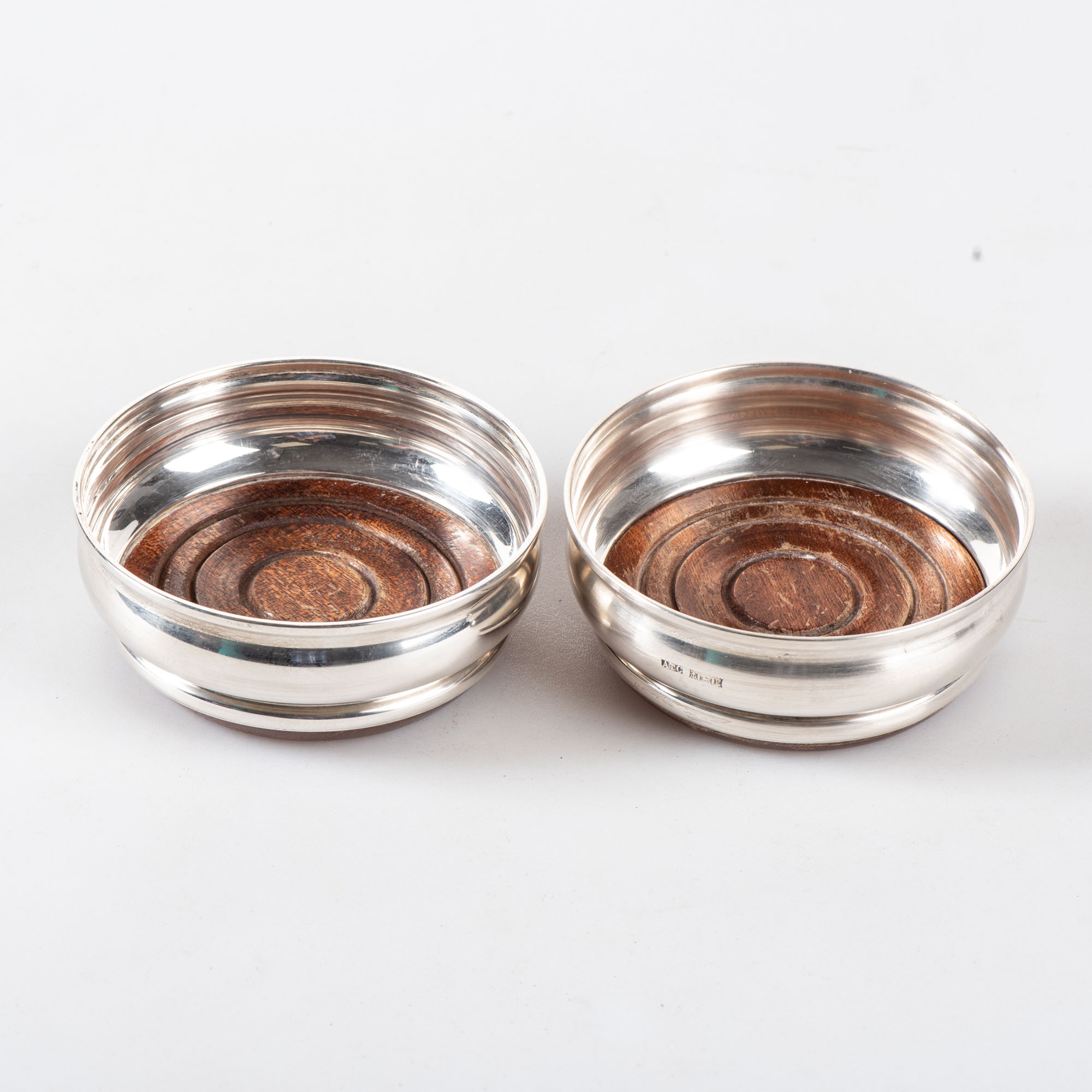 A PAIR OF SILVER WINE COASTERS