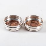 A PAIR OF SILVER WINE COASTERS