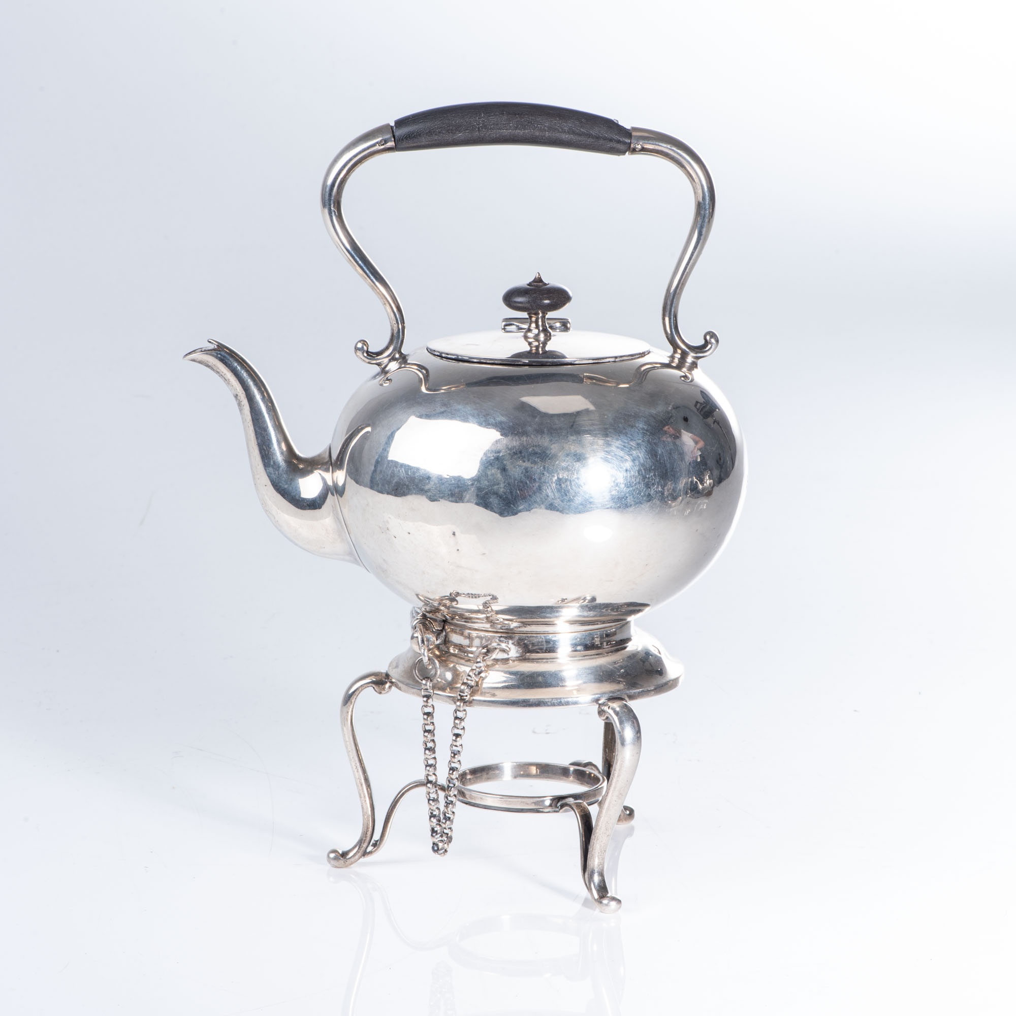 A SILVER TEA KETTLE ON STAND