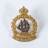 A BRITISH WWI DRAKE BATTALION CAP BADGE