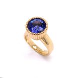 A TANZANITE TUBE SET RING WITH A BROAD BAND