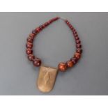 ANTIQUE BRASS AND COPPER TAUREG PENDANT AND ROUND RED AFRCAN AMBER FROM ETHIOPIA