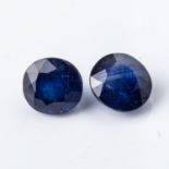 A PAIR OF UNSET SAPPHIRES