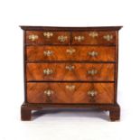 A GEORGE III WALNUT CHEST-OF-DRAWERS