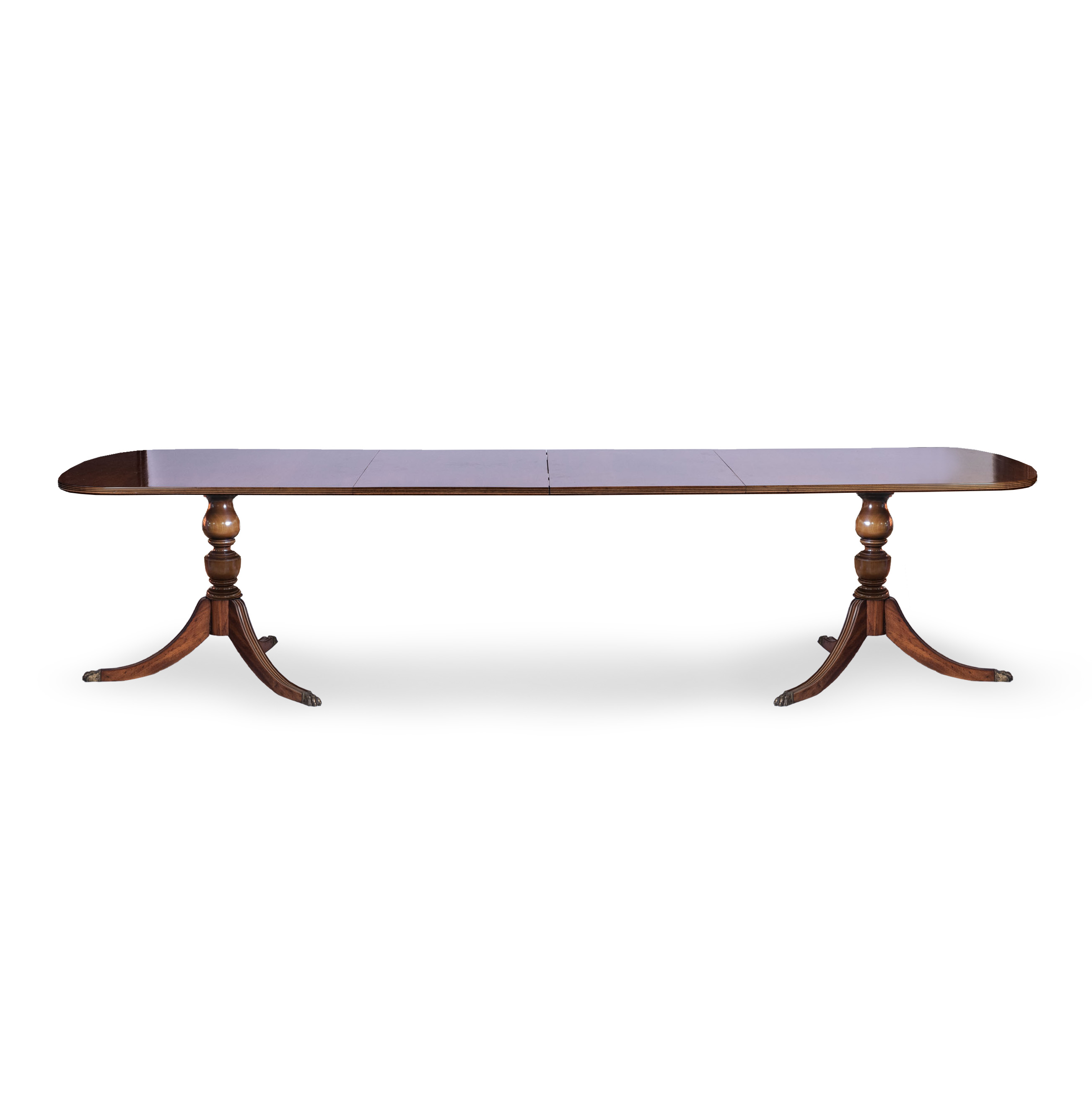 A REGENCY STYLE MAHOGANY EXTENDING DINING TABLE