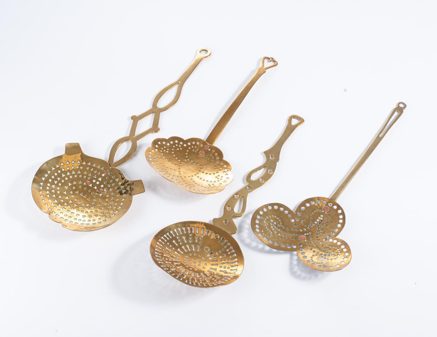 A COLLECTION OF FOUR ASSORTED BRASS STRAINING LADLES