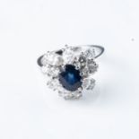 A SAPPHIRE AND DIAMOND CLUSTER RING