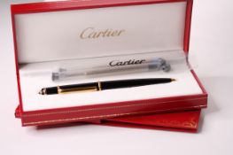 Diabolo de Cartier Rollerball Pen with a black composite body, yellow golden finish trim details,