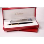 Diabolo de Cartier Rollerball Pen with a black composite body, yellow golden finish trim details,