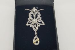 Diamond Set Flower Pendant, suspended open teardrop with a diamond set yellow gold detail, stamped