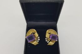 Pair of 1960’s Amethyst Scroll Earrings, claw set amethysts wrapped in a ribbon of gold with 3