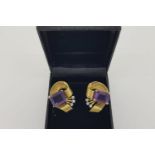 Pair of 1960’s Amethyst Scroll Earrings, claw set amethysts wrapped in a ribbon of gold with 3