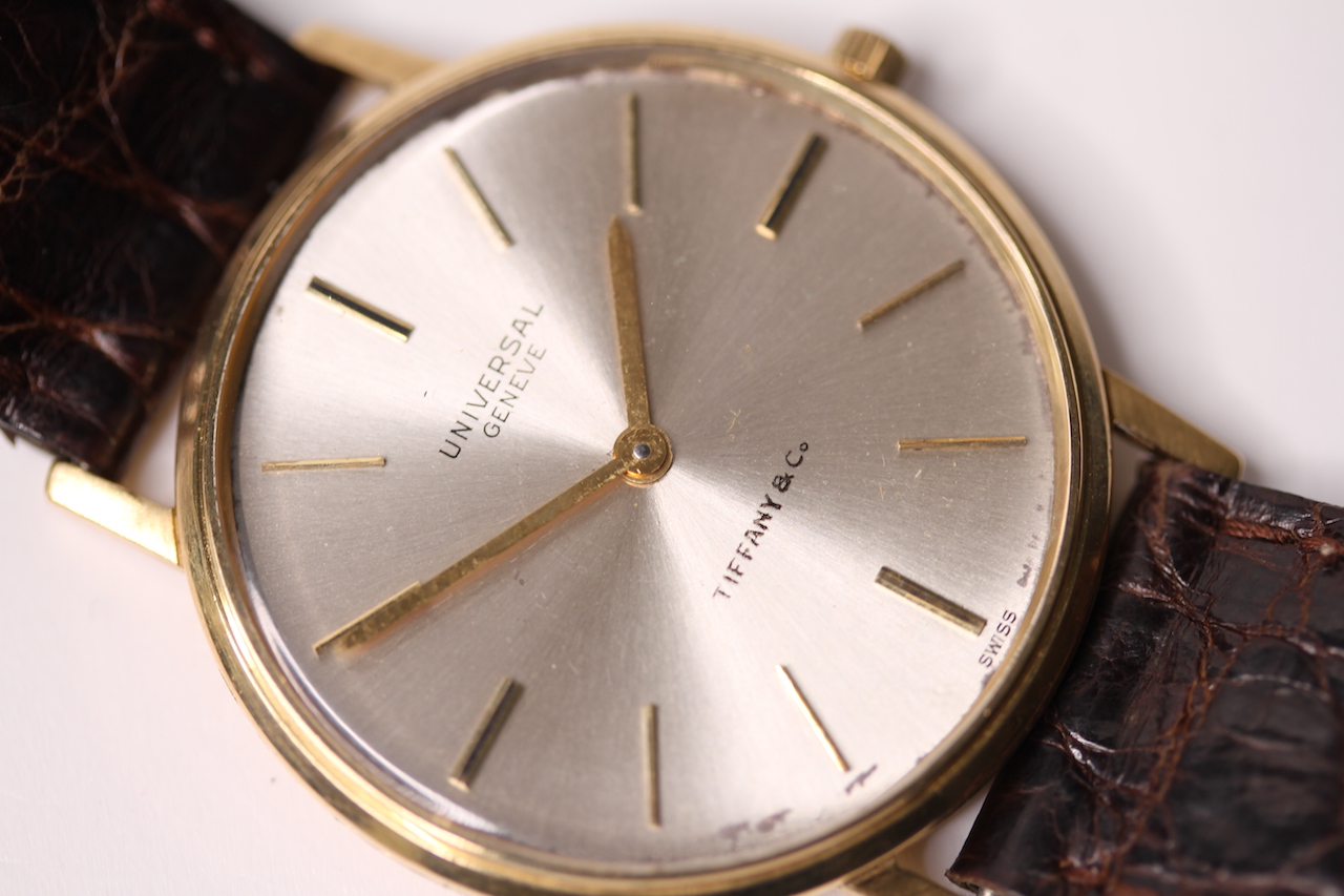 1960S UNIVERSAL GENEVE X TIFFANY & CO 18CT DRESS WATCH, circular off white dial, gold baton hour