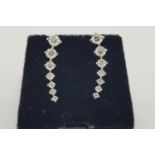 Pair Of Graduated Diamond Earrings, 7 claw set diamonds graduating in size as they taper upwards,