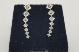 Pair Of Graduated Diamond Earrings, 7 claw set diamonds graduating in size as they taper upwards,