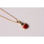 Enamel Red Lady Bird Pendant and Chain, 38cm chain, in yellow gold stamped and tested as 18ct