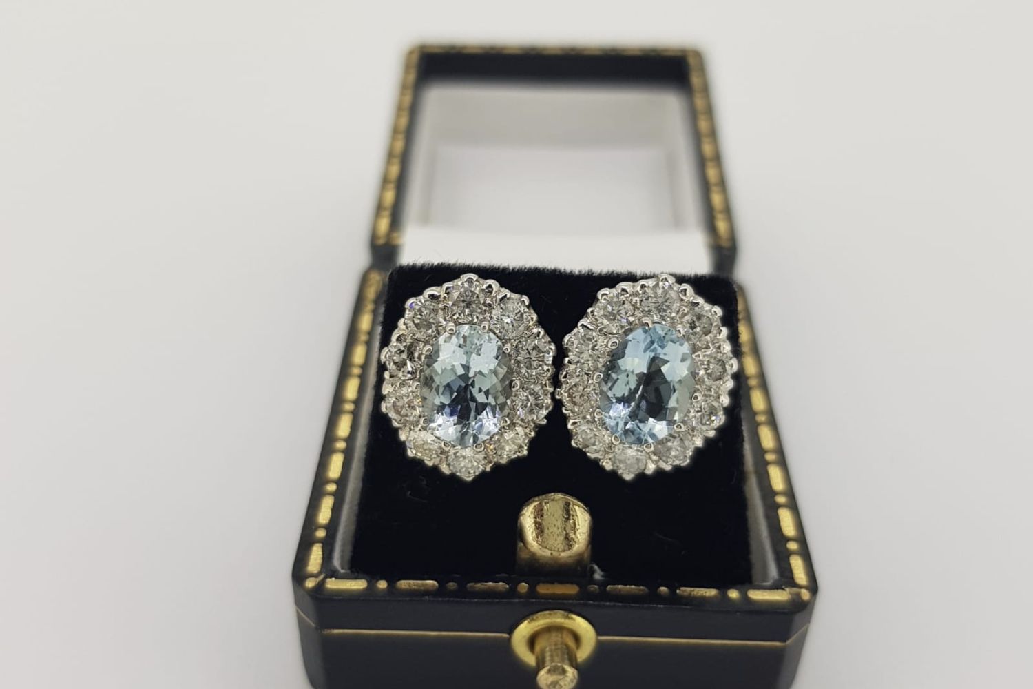 Pair of Aquamarine & Diamond Cluster Earrings, claw set central oval cut aquamarines are