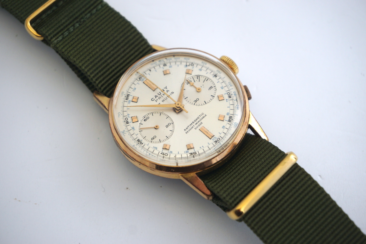 VINTAGE CAUNY PRIMA CHRONOGRAPH WRIST WATCH, circular sunburst silver dial with two subsidiary