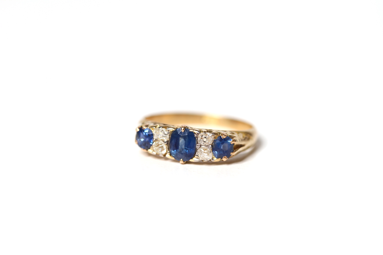 Early 20th Century Sapphire and Diamond Carved Half Hoop Ring, three sapphires, old cut diamond