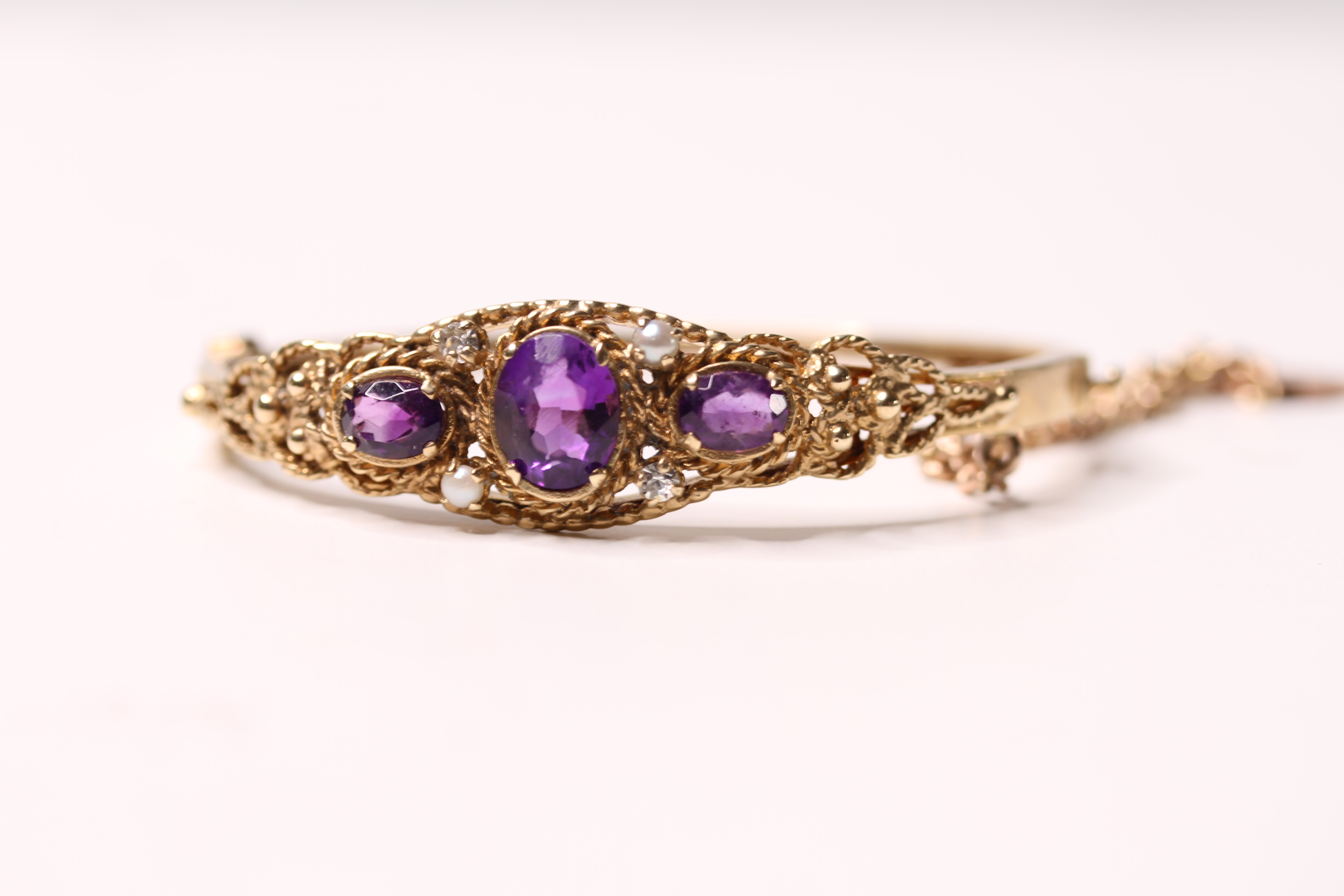 *TO BE SOLD WITHOUT RESERVE*A Victorian style amethyst and split pearl hinged bangle,