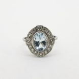 Aquamarine & Diamond Ring, oval aquamarine in a rub over setting, inside a diamond compass design