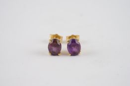 18CT GOLD AMETHYST SET STUD EARRINGS, a pair of 18ct gold studs set with est. 1ct amethyst