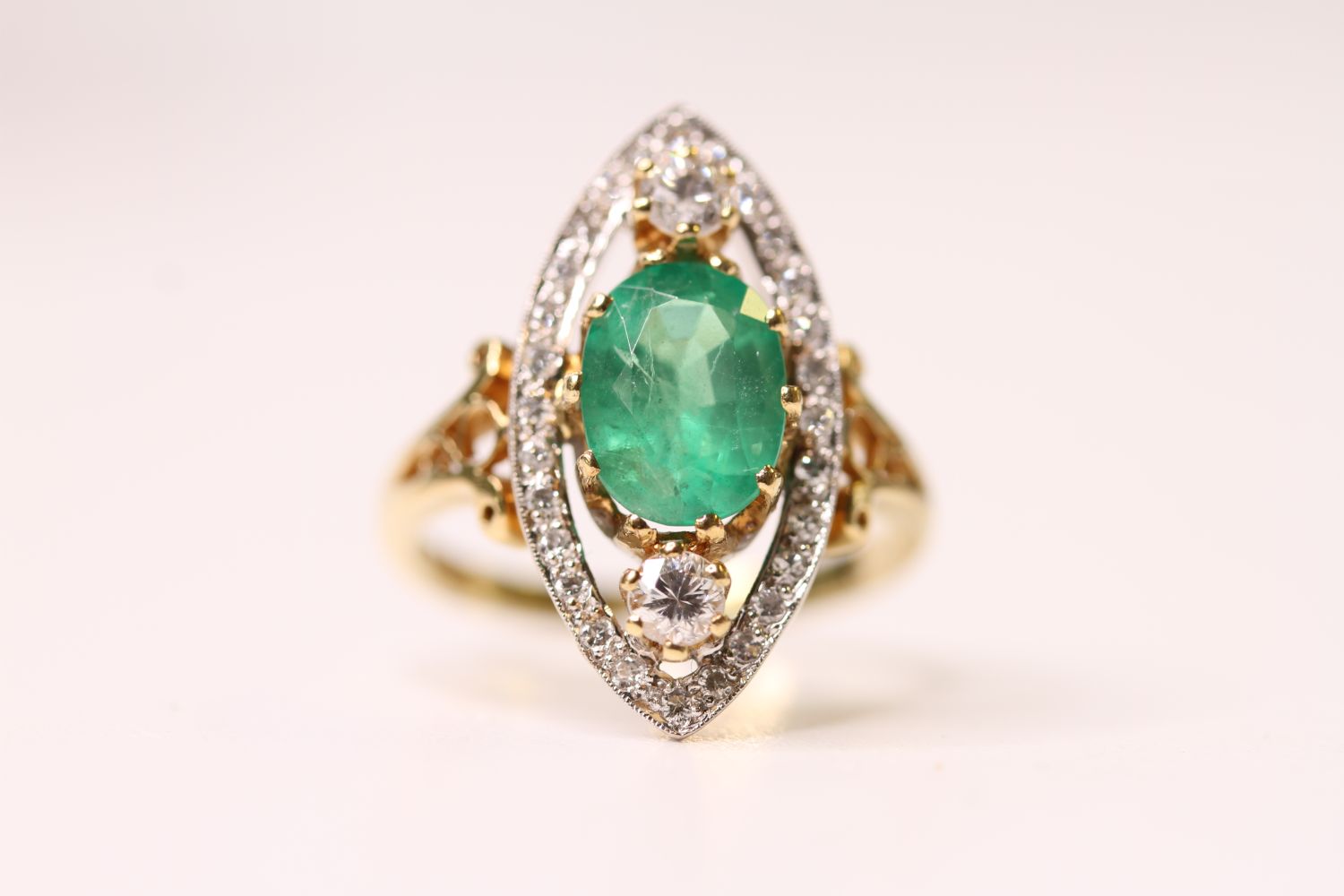 Emerald & Diamond Marquise Shaped Ring, set with a central oval emerald inside a diamond open